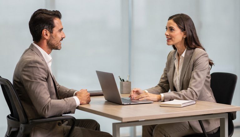 Leidinggevende die hoogbegaafde medewerker motiveert tijdens één-op-één gesprek op kantoor
